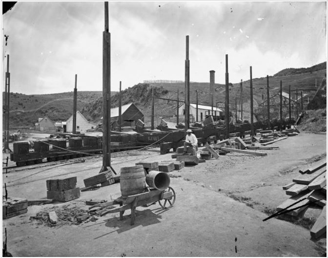 View of the patent slip at Evans Bay, Wellington, looking north from the harbour, showing a wheelbarrow in the foreground. Photograph taken ca 1880 by an unknown photographer.  National Library reference: 10x8-1824-G