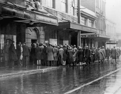 Waterside workers entering the Trades Hall in Vivian Street, Wellington. Original photographic prints and postcards from file print collection, Box 12. Ref: PAColl-6348-37. Alexander Turnbull Library, Wellington, New Zealand. http://natlib.govt.nz/records/22631763