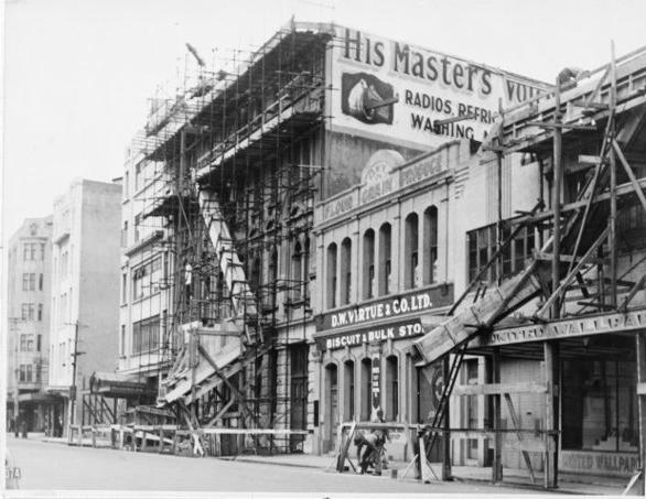 c.1942 - This photograph probably shows repairs after the 1942 Wairarapa Earthquake. National Library reference: E J Hyams Ltd Building on Wakefield Street, Wellington. EMI :Photographs relating to EMI and His Master's Voice NZ Ltd. Ref: PAColl-0646-06. Alexander Turnbull Library, Wellington, New Zealand. http://natlib.govt.nz/records/23098791